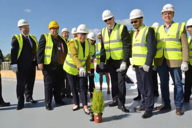 Topping out ceremony at the new West Town school site at Thorpe Road. PCC leader John Holdich with school principal Jane Dooley with Kier staff and guests. EMN-160524-135822009