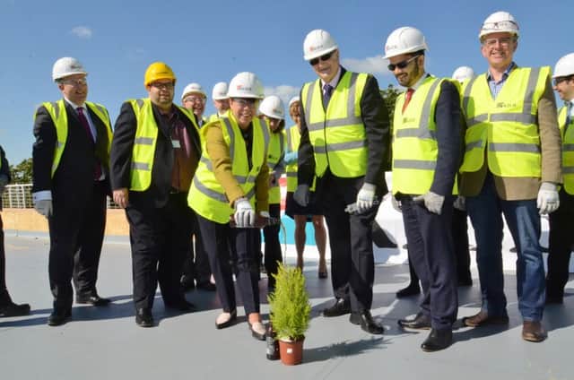 Topping out ceremony at the new West Town school site at Thorpe Road. PCC leader John Holdich with school principal Jane Dooley with Kier staff and guests. EMN-160524-135822009