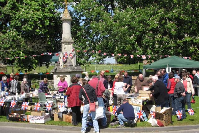Stalls around the John Clare Memorial on the Village Green EMN-160525-100817001
