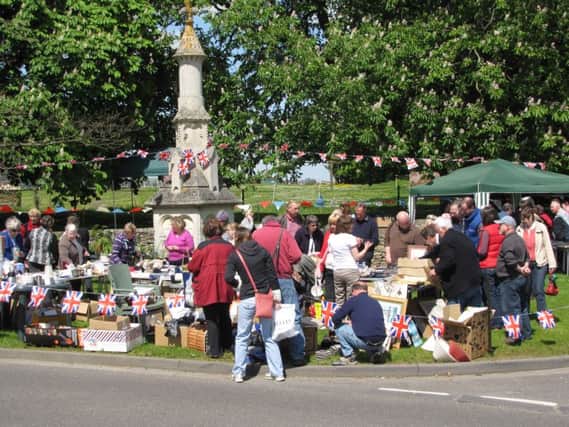 Stalls around the John Clare Memorial on the Village Green EMN-160525-100817001