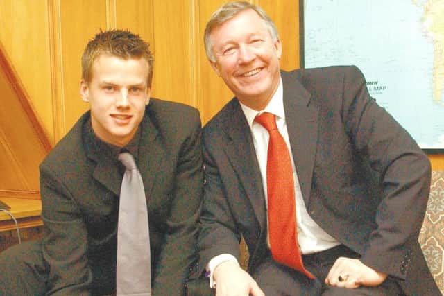 Luke Steele signs for Manchester United in the presence of Sir Alex Ferguson.