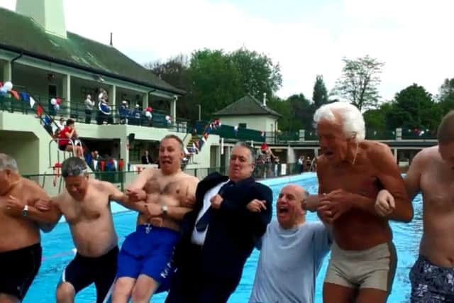 Mayor of Peterborough Cllr David Sanders and swimmers jump into the Lido