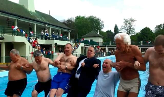 Mayor of Peterborough Cllr David Sanders and swimmers jump into the Lido