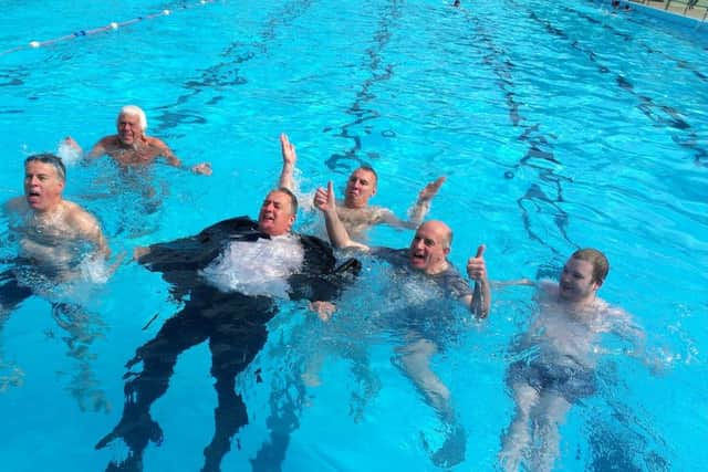 Mayor of Peterborough Cllr David Sanders and swimmers jump into the Lido