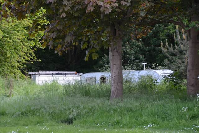 Three traveller caravans hidden inside a small wooded area at Hartwell Way EMN-160527-184946009
