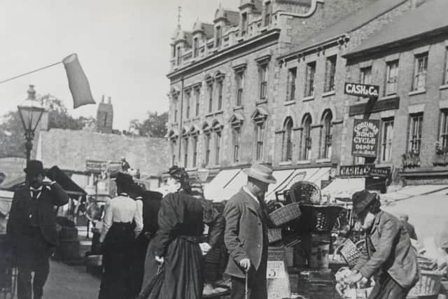 Traders doing brisk business on Long Causeway. Can you date the picture?