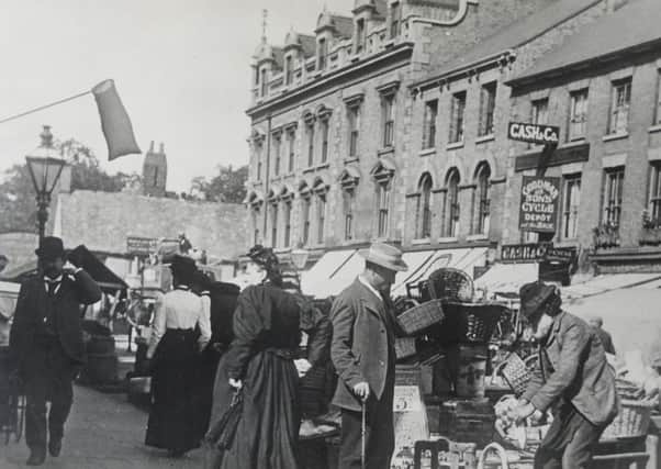 Traders doing brisk business on Long Causeway. Can you date the picture?