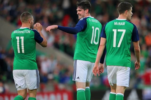 Northern Ireland's Conor Washington (left) celebrates with team-mate Kyle Lafferty (centre) after scoring his side's second goal during the International Friendly at Windsor Park, Belfast. Picture: Niall Carson/PA Wire.