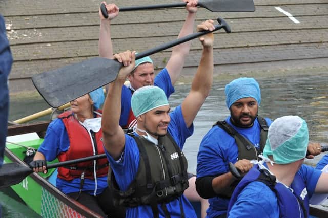 Dragon Boat racing at Thorpe Meadow.  Action of the crews on the water -in the Fitzwilliam Hospital boat Louis Smith EMN-150613-173323009