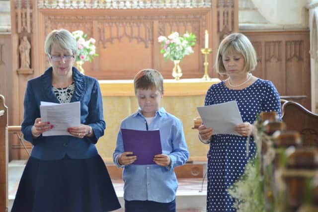 Etton Church -  reading of  letters from soldiers serving in WW1   during a service. Pictured are readers Anne Curwen, Alex Long (7) and Helen Morton. EMN-160406-203127009