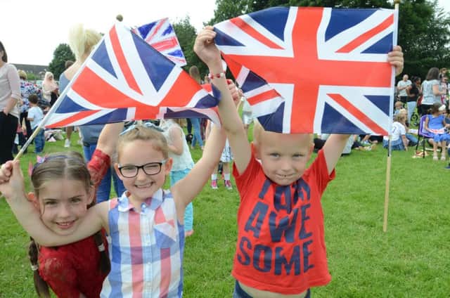 Queen's 90th birthday celebrations at Woodston  Primary School. Pupils Bethany-Ruth, Zahra and Alexys with flags EMN-161006-155453009