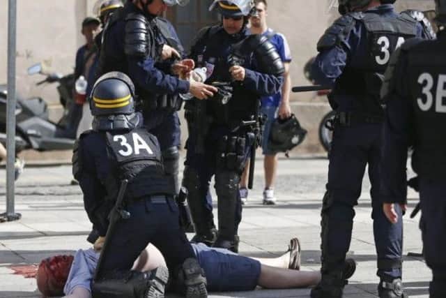 Police try to resuscitate an England fan after the violence in Marseille