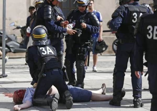 Police try to resuscitate an England fan after the violence in Marseille