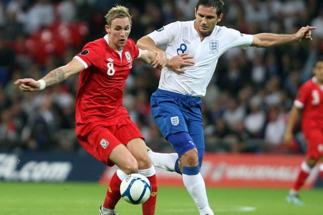 Jack Collison challenges Frankl Lampard in an England v Wales match in a European Championship qualifying match in 2011.
