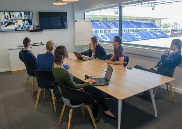Staff at work in the ABAX UK office at the ABAX stadium.