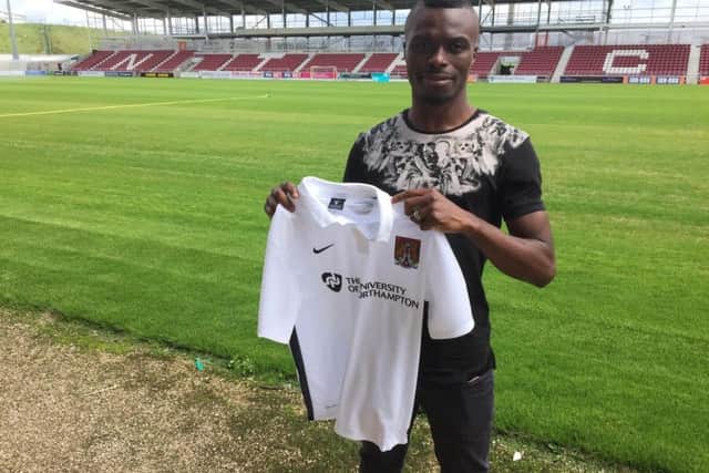 Gaby Zakuani with a Northampton Town shirt.