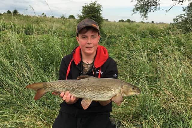 Thomas Moore (14) with his first barbel caught on the Nene.
