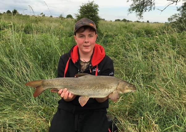 Thomas Moore (14) with his first barbel caught on the Nene.