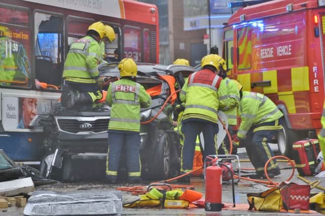 RTC involving a car and bus in Broadway, Peterborough City Centre. Bus collided with building, person trapped in the car involved. EMN-151224-145650009