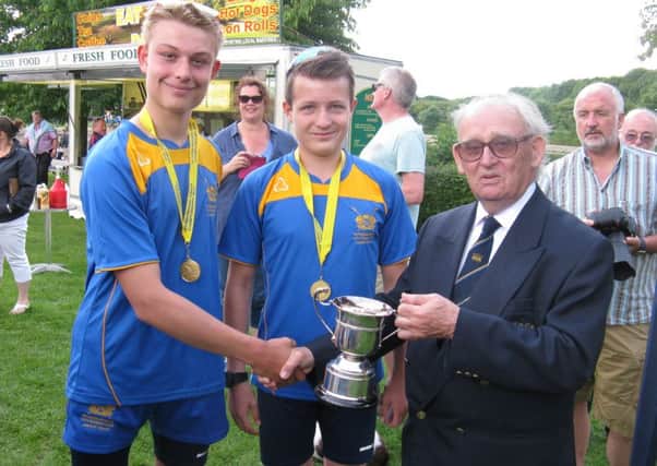 Double sculls winners James Toynton and Alex Leverage receive their trophy from club president Bob Bridges.