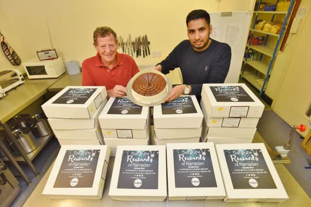 John Freeman from the Soup Kitchen receiving cakes from Shafeel Hussain representing Team Hope from Islamic Relief EMN-160625-183006009