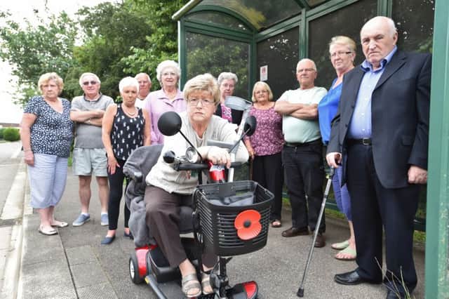 Dorothy Haynes on her scooter at Keys Park  where the paths are uneven and buses infrequent - pictured with some of her neighbours EMN-160607-172940009
