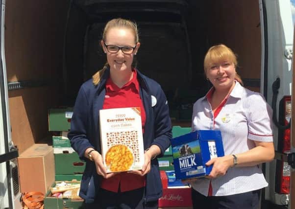 Community Champion Charlotte Fountain (Left) and Services Manager Selina Letts (Right) loading up the Foodbank van with the donations from Tesco Extra Hampton