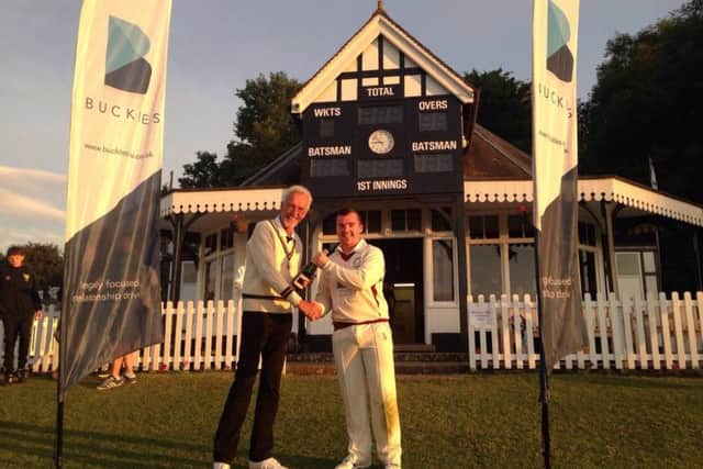 Baston's Robert Dunn receives his 'champagne moment' prize from umpire Derek Patience.