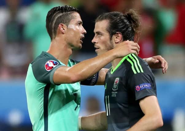Unlucky mate! Cristiano Ronaldo comforts Gareth Bale.