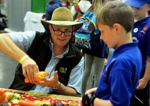 Andrew Burgess of Produce World demonstrates veg art to one of the children who attended Kids Country Food and Farming Day.