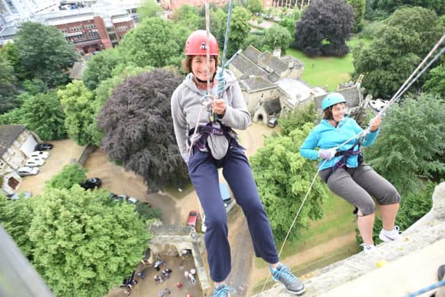 Abseiling down corner of the Peterborough Cathedral West Front EMN-160907-175129009