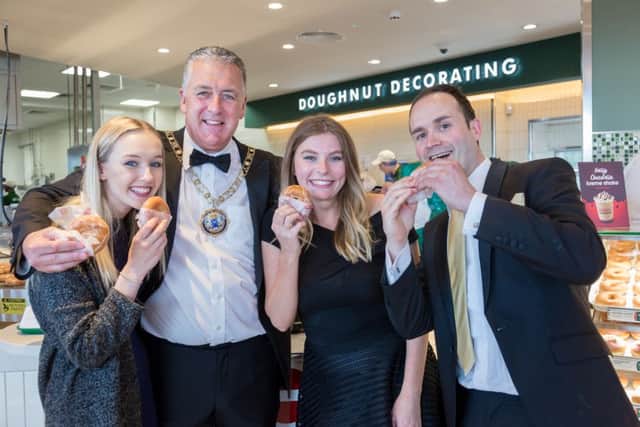 Mayor David Sanders gets a taste of Peterborough's new Krispy Kreme at the launch night