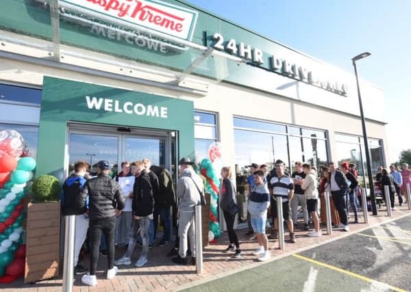 People lined the street outside Krispy Kreme Doughnuts in anticipation of its opening this morning