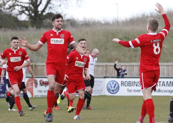 Tom Batchelor celebrates the winning goal for Stamford against Grimsby. Photo: Geoff Atton.