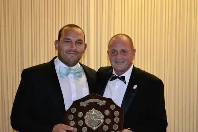 Borough player of the year Stuart Day receives his trophy from club vice-chairman Archie Bennett.