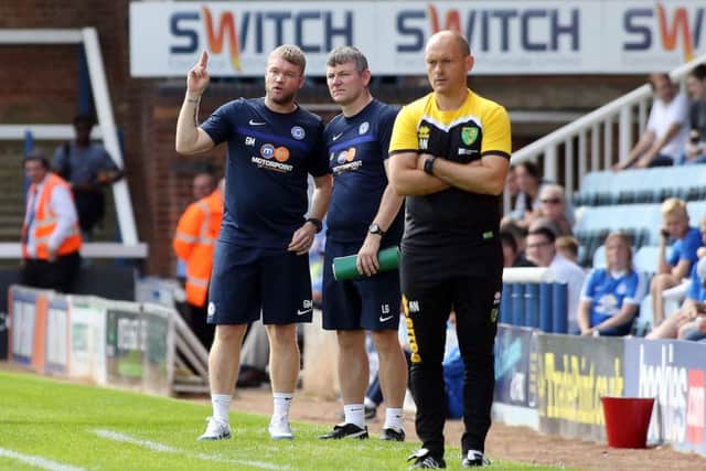 Posh manager Grant McCann in conversation with assistant boss Lee Glover during the game against Norwich. Photo: Joe Dent/theposh.com.