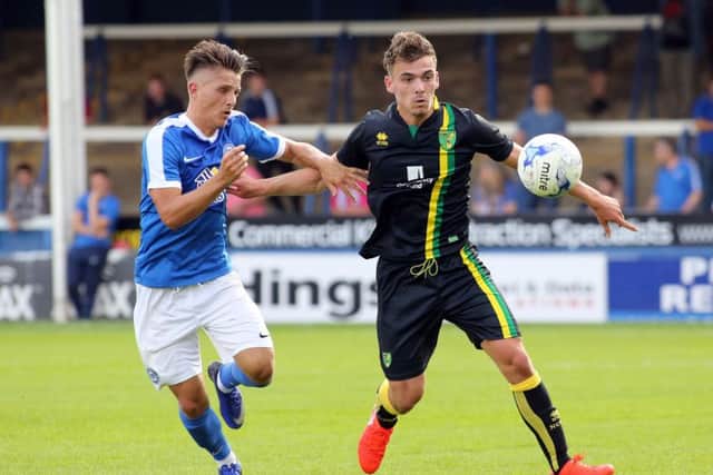 Tom Nichols (left) competes with Harry Toffolo in the Posh v Norwich friendly match. Photo: Joe Dent/theposh.com.