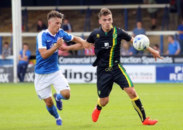 Tom Nichols (left) competes with Harry Toffolo in the Posh v Norwich friendly match. Photo: Joe Dent/theposh.com.