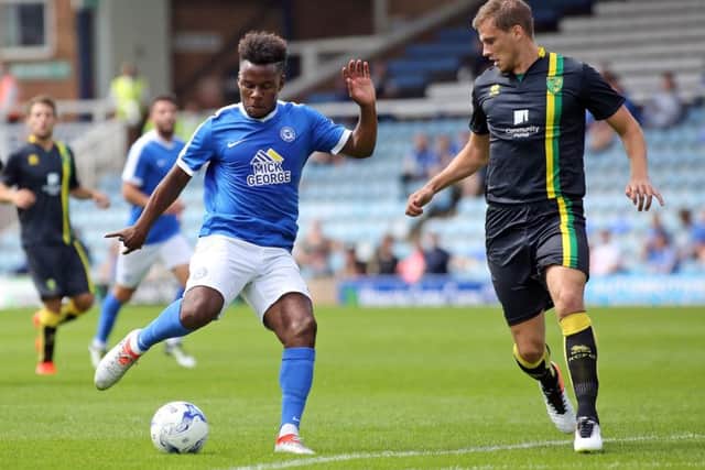 Shaquile Coulthirst, watched by Norwich defender Ryan Bennett, shoots on goal for Posh. Photo: Joe Dent/theposh.com.