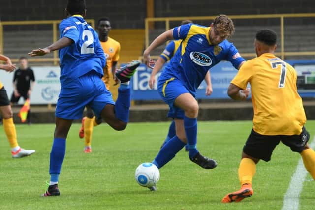 Action from Boston United v Spalding (blue) in the Lincs Senior Cup.