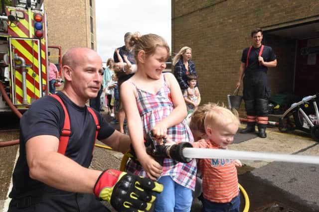 Dogsthorpe fire station open day -  fire fighter Barry Boreham with  Maddison and Oliver Gilbert EMN-160717-090619009