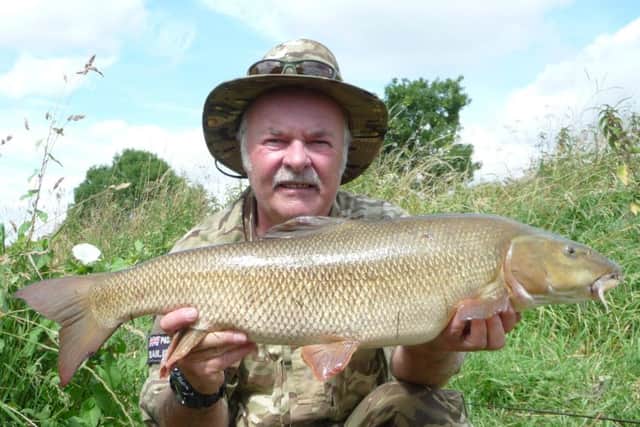 Peterborough bailiff Mark Smith is pictured with an 11lb 6oz barbel - one of three he caught during a short stint along the Castor section of the Nene. Multiple barbel catches are  far from normal on the Nene, especially in the current hot conditions, so one was good, three is exceptional. He caught all three fishing on a glugged 12mm halibut with a maggot feeder full of pellets to give off a constant scent trail and fished over a bed of hemp.