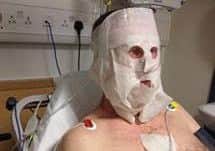 Civil servant Guy McCallan in his hospital bed after the incident