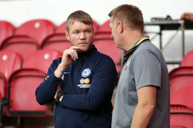 Posh manager Grant McCann before the game with Brentford boss Dean Smith. Photo: Joe Dent/theposh.com.