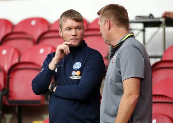 Posh manager Grant McCann before the game with Brentford boss Dean Smith. Photo: Joe Dent/theposh.com.