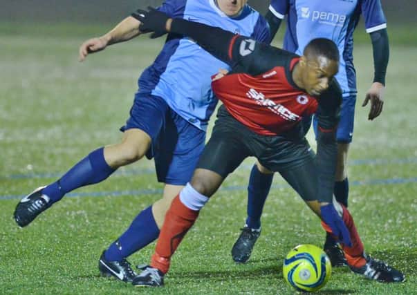 Dwayne Rankin (red) in action for Netherton United.