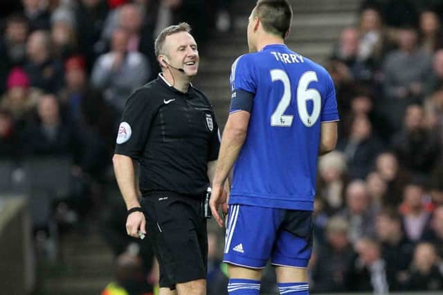 Referee Jon Moss clearly enjoys John Terry's company.