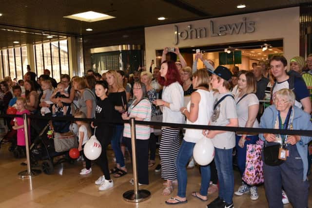 Shoppers outside the new H&M store in Queensgate