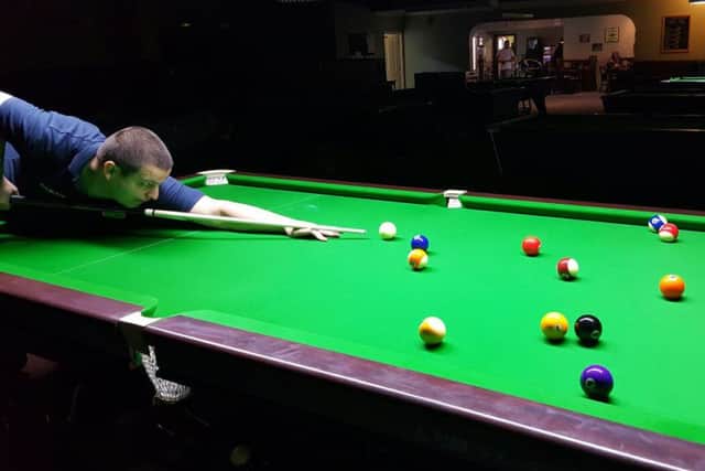 Court pool and snooker club manager Ivan Knight on a new Cheinese 8-ball pool table at his club.