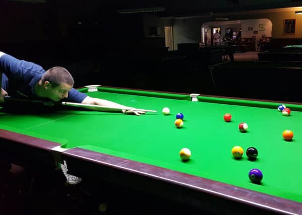 Court pool and snooker club manager Ivan Knight on a new Cheinese 8-ball pool table at his club.